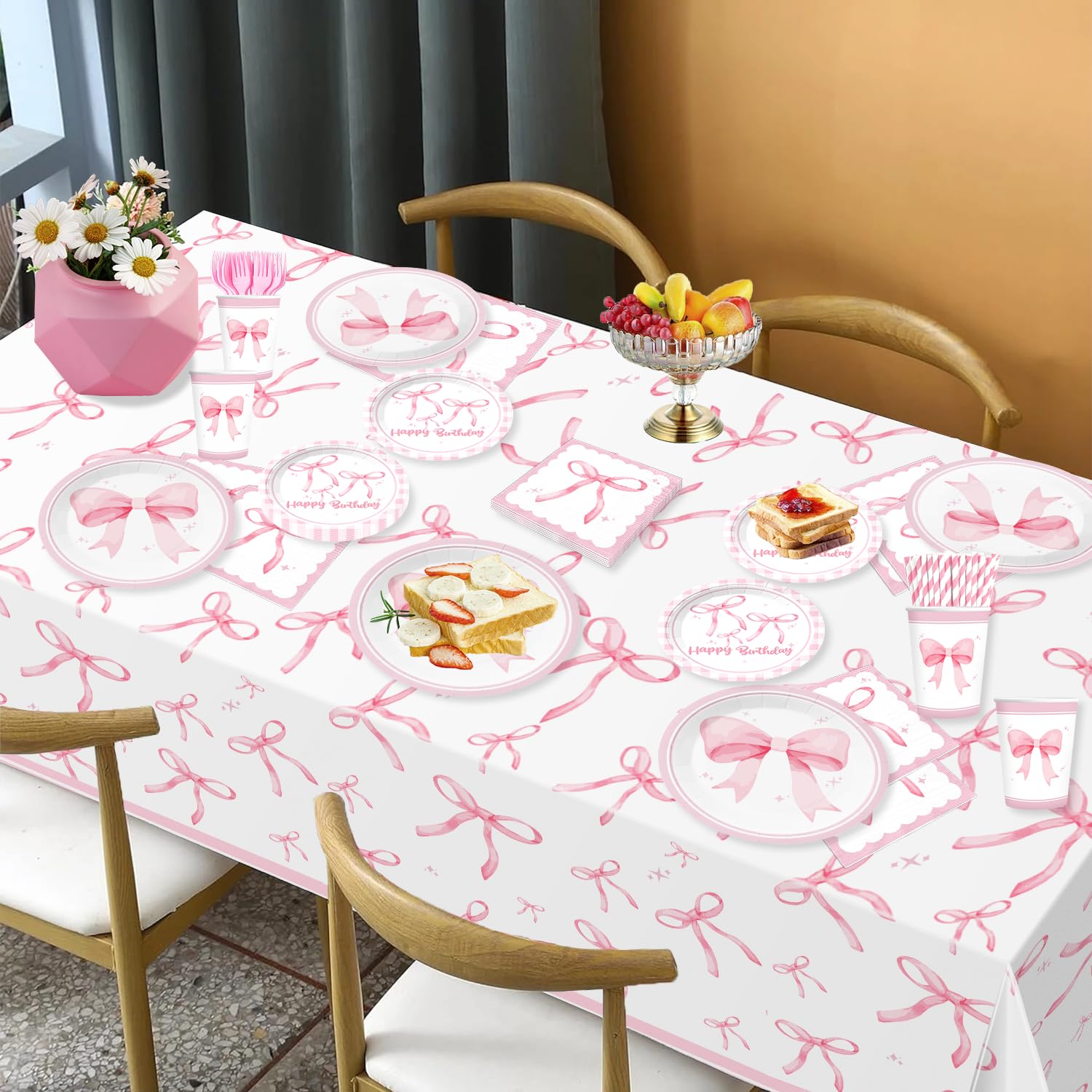 Generic Coquette tablecloth, balloons, and cake topper create a festive centerpiece.