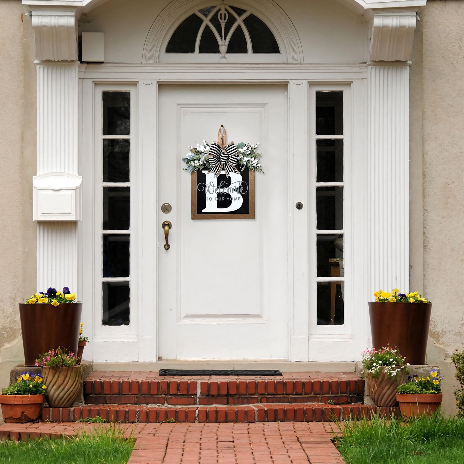 Generic eucalyptus garland and bow adorns front door for seasonal styling