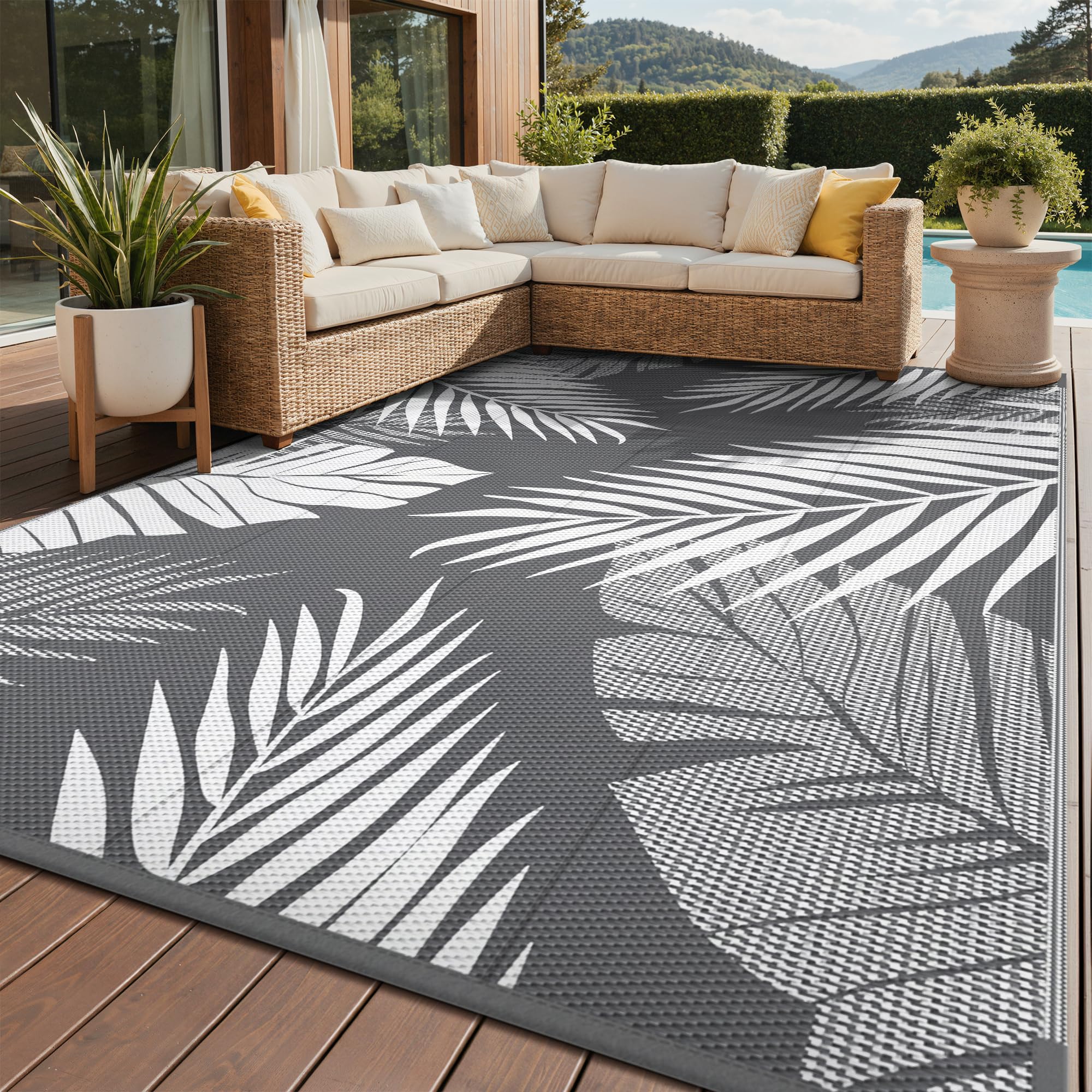 GENIMO outdoor rug with palm leaf pattern, waterproof and durable for patios.