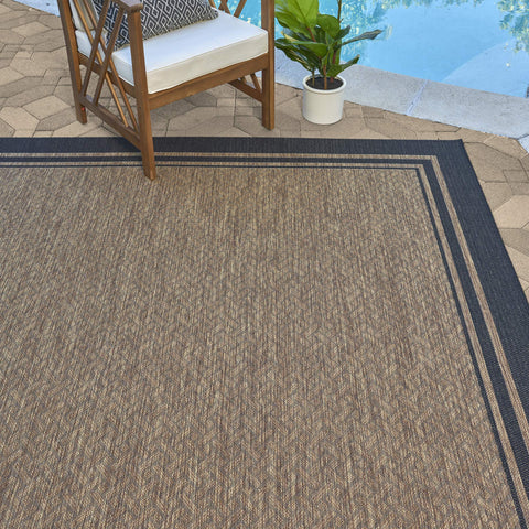 Gertmenian classic flatweave rug border in black and tan for outdoor and indoor spaces.