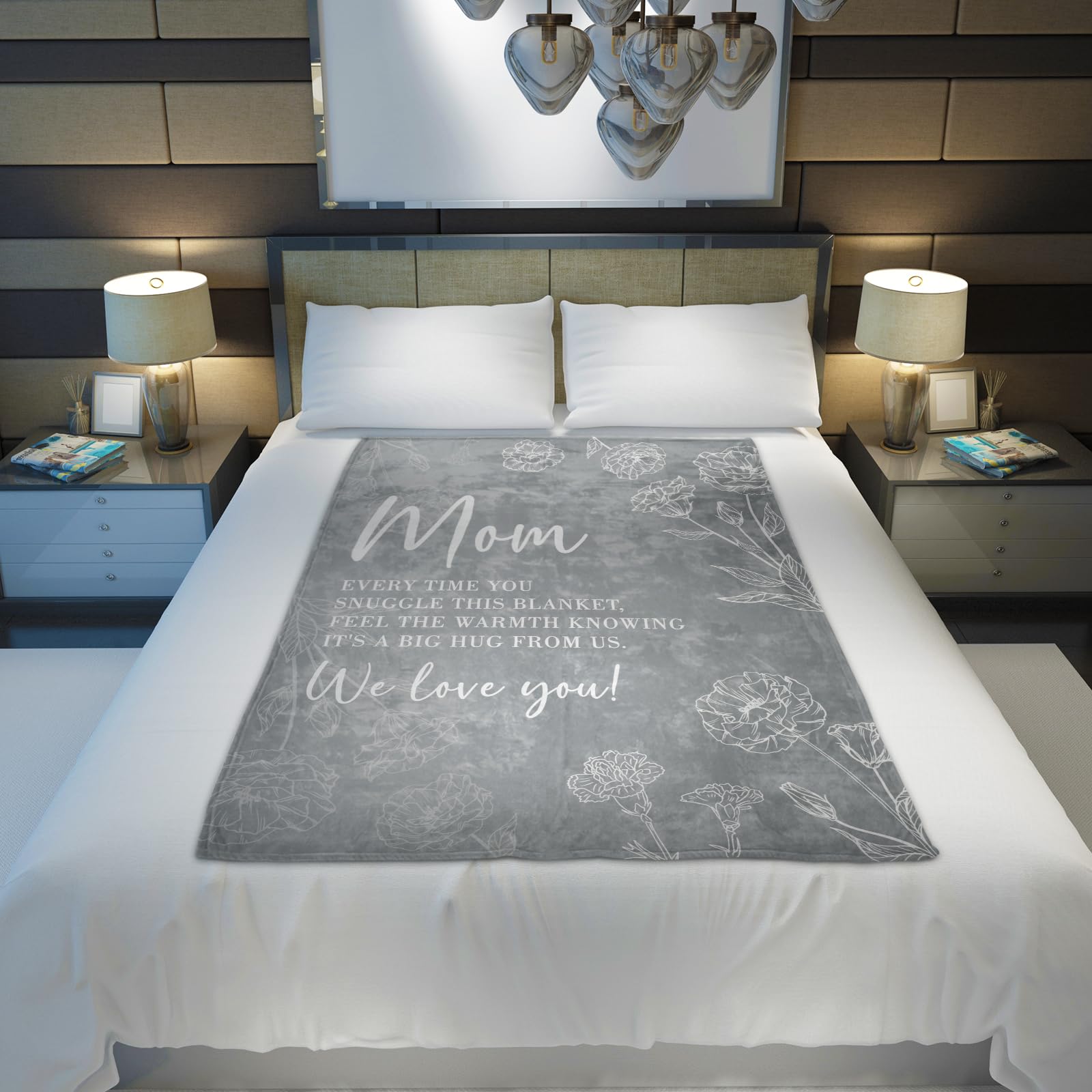 GiltGlimmer grey blanket draped on bed for cozy lounging.