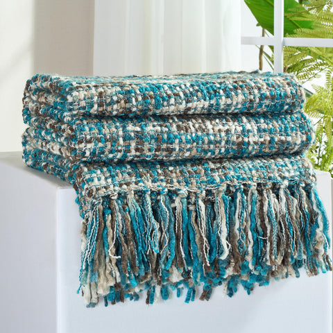GINAMUSE multi-color teal cable woven throw on couch adds cozy decor.