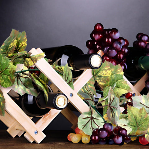 Stage backdrop with hanging grape garland creates depth.