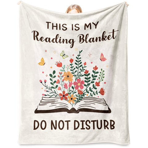 Glydein Book Lovers Blanket on sofa for cozy reading sessions.