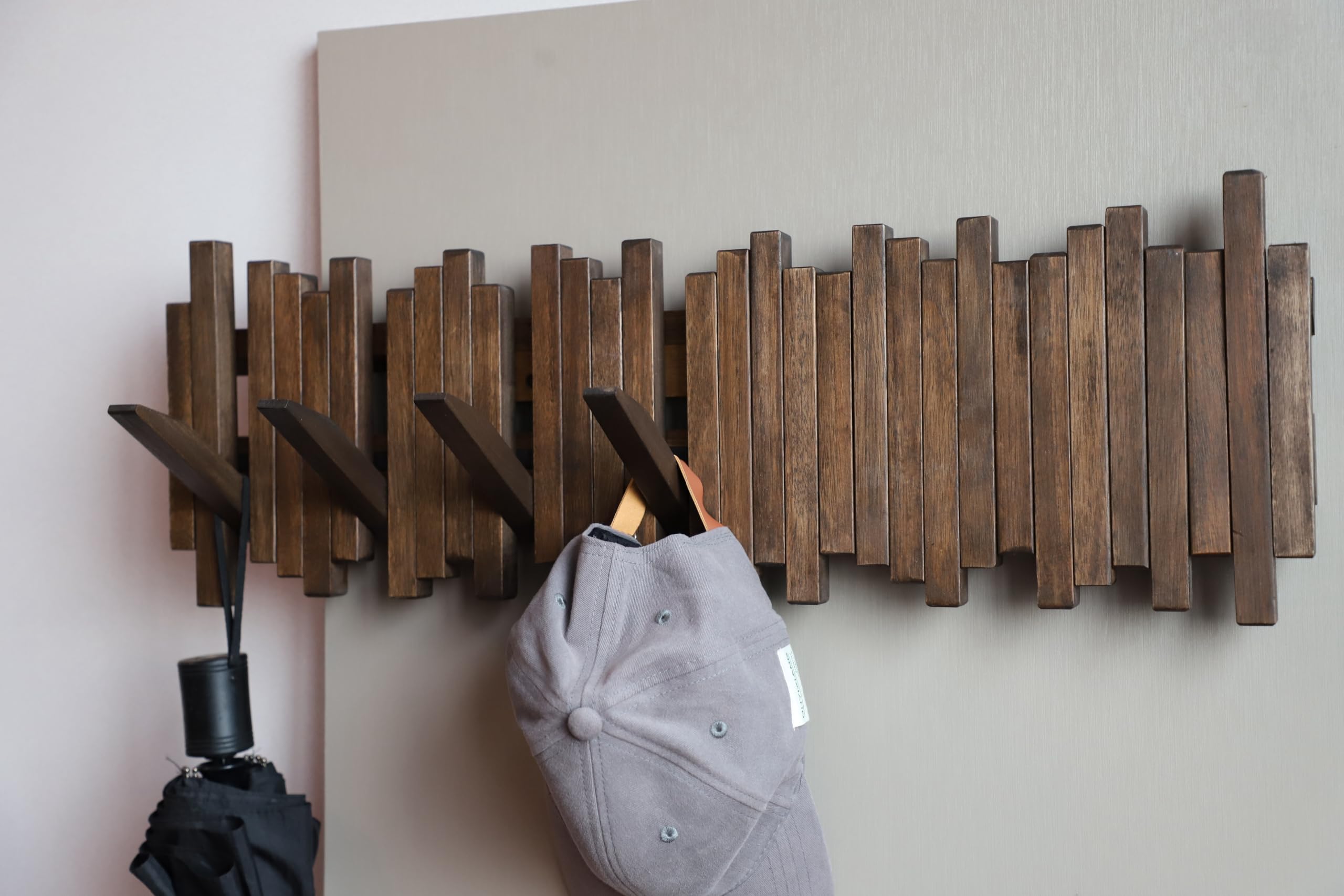 GOGREEBELL flip-down hooks in uplocked position for a clean, clutter-free wall.