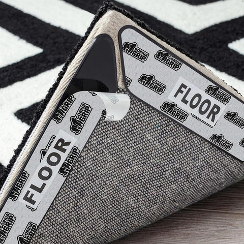 GORILLA GRIP Rug Gripper Pads installed under rug corners to prevent curling on hardwood floors.