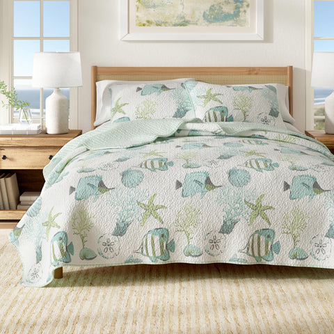 Great Bay Home coastal quilt set on a bed with fish and coral for beachy decor.