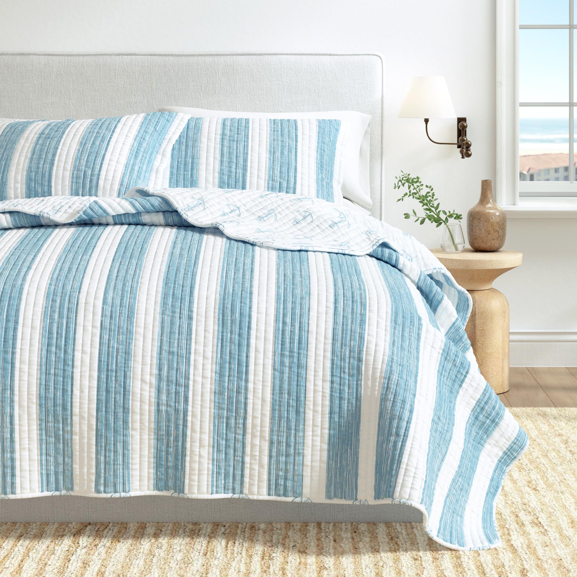 Great Bay Home beach-inspired design enhances guest or master bedroom.