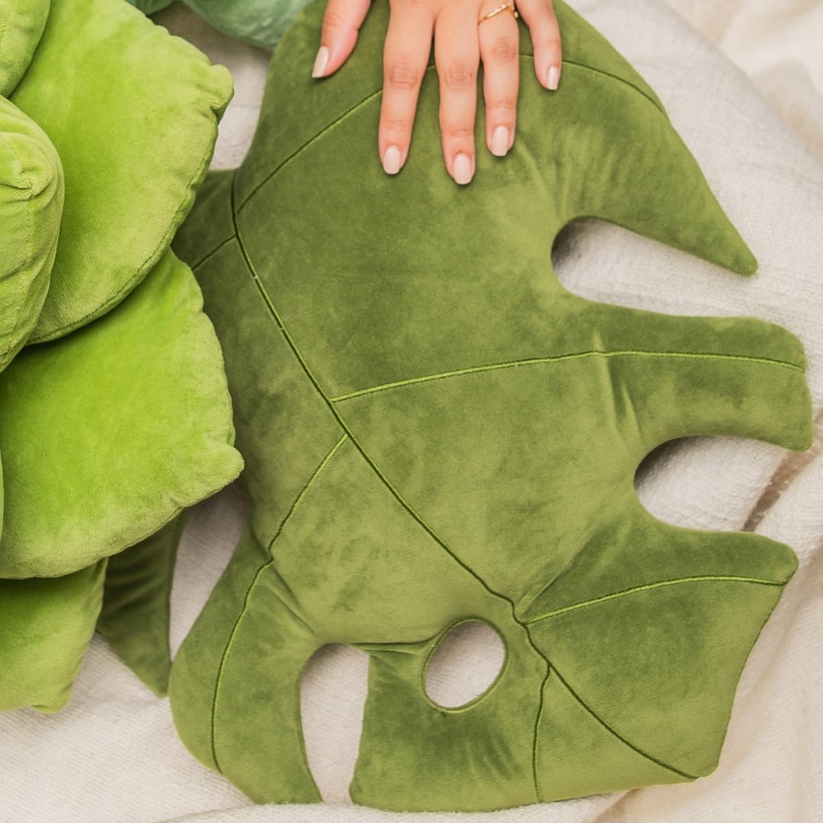 Green Philosophy Co. Monstera Leaf Pillow bed setup demonstrates versatile comfort and decorative charm.