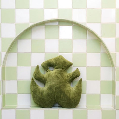 Green Philosophy Co. Monstera Leaf Pillow layered with other cushions boosts cozy decor.