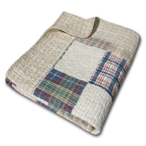 Oxford throw blanket in tan on bed, showcasing durable cotton texture.