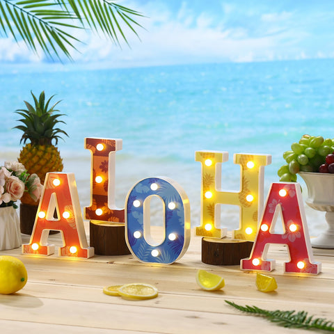 Grinsvalley outdoor beach party ambience with illuminated luau sign.