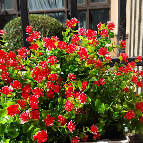 Grunyia red outdoor artificial flowers in a lush window box arrangement