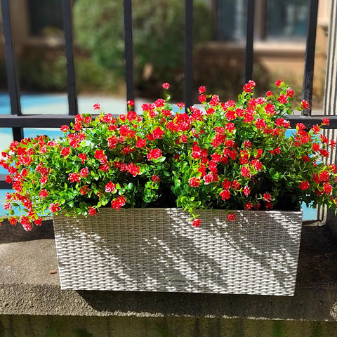 Grunyia red outdoor artificial flowers in a front porch planter setup