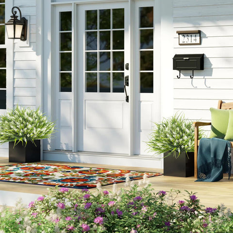 Grunyia outdoor decor featuring monkey grass and white flowers as a wedding backdrop.