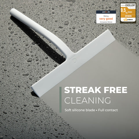 GÜTEWERK squeegee with stainless-steel core demonstrates durability while cleaning wet surfaces.