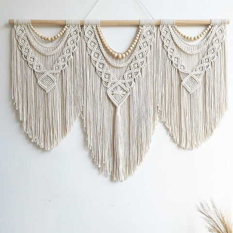 Guzhiou large macrame wall hanging with fringe adds texture to a bedroom.