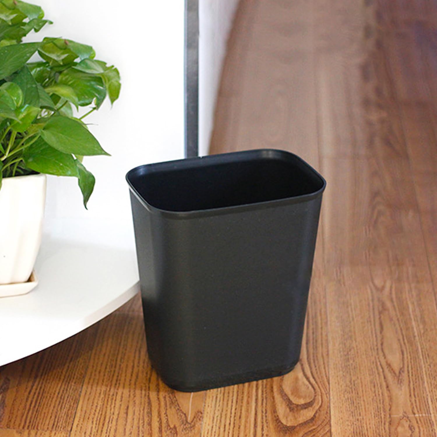 Halyuhn plastic trash bin small-space solution near desks.
