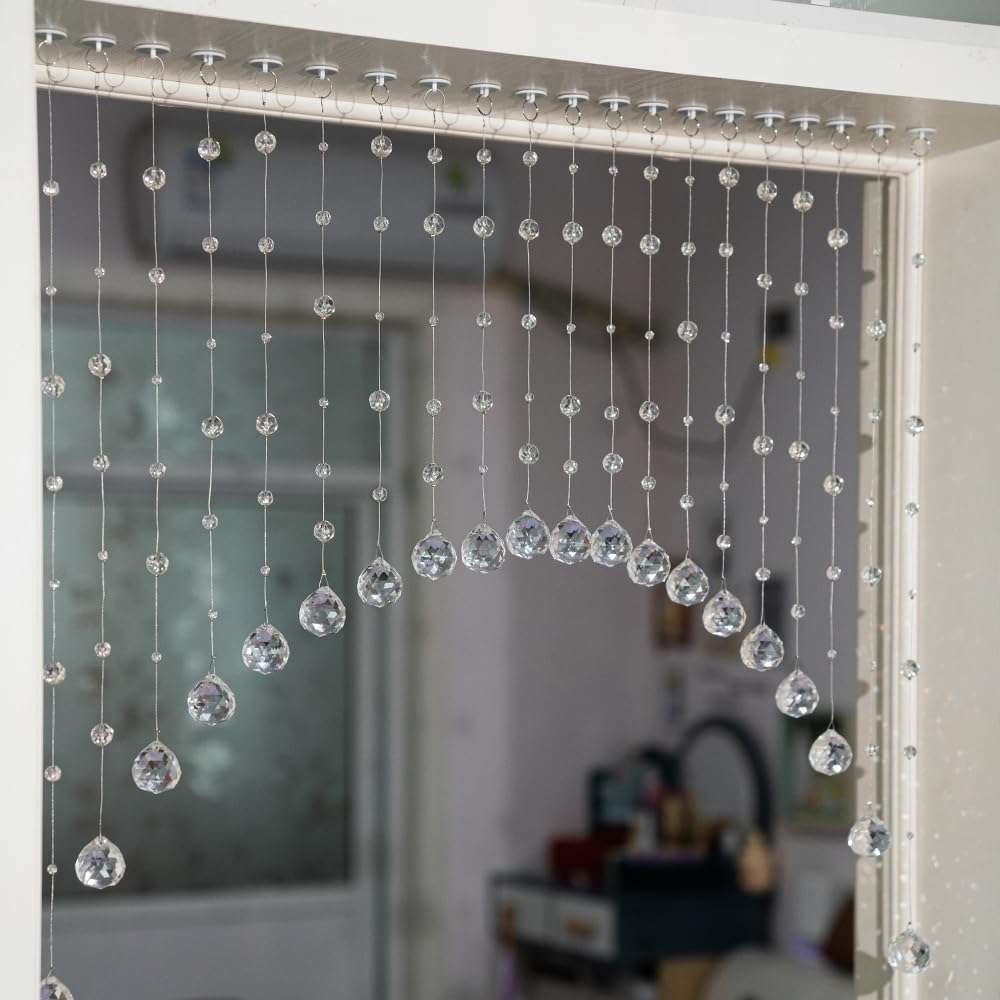 Hanbinsen crystal bead curtain arches over a doorway to diffuse light elegantly