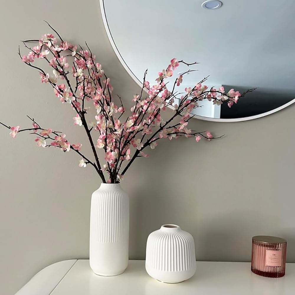 HANDIC cherry blossom branches arranged on a table for a lush display.