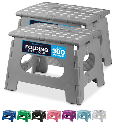 Handy Laundry folding step stool in grey, open, showing easy access to high shelves.