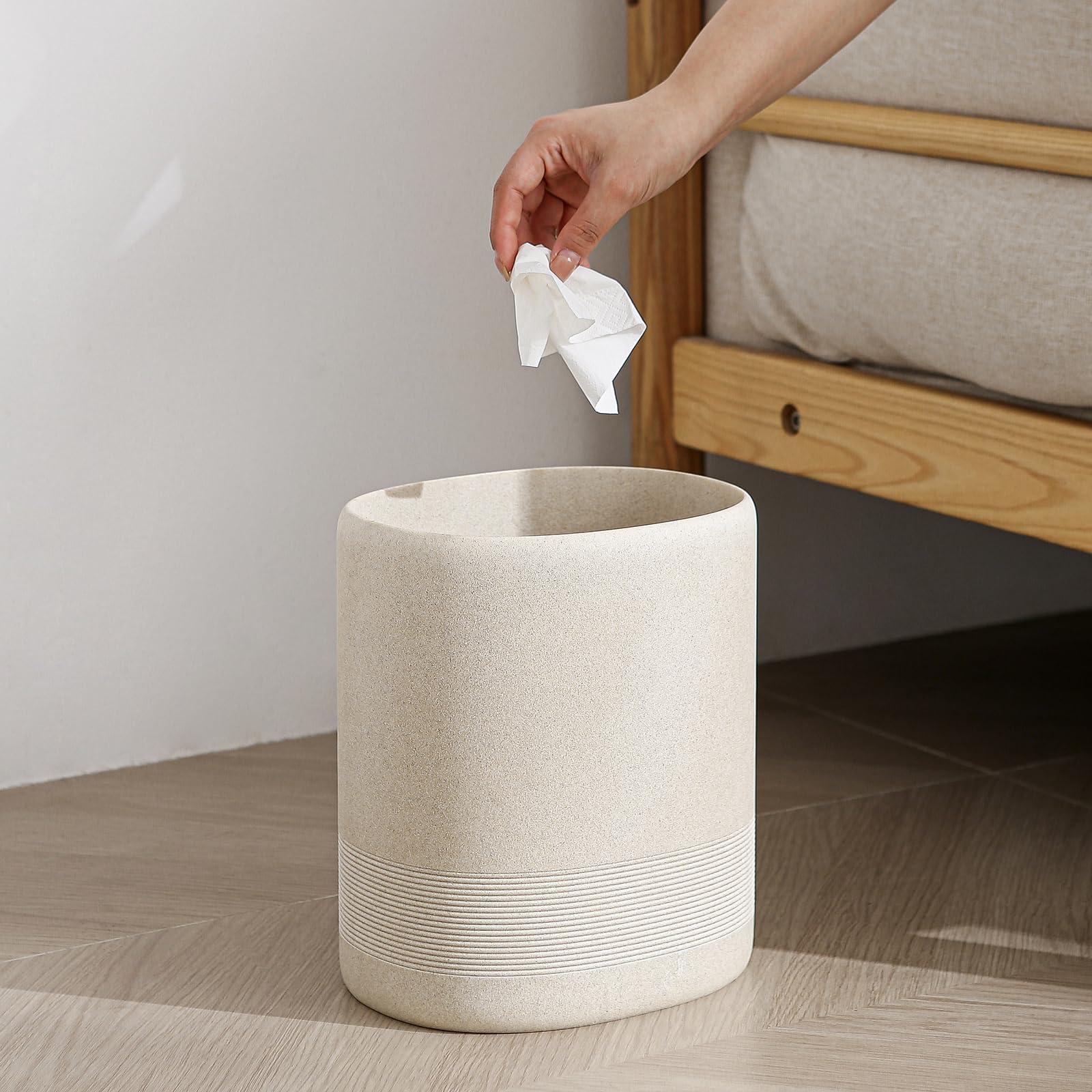 Space-saving oval trash bin fits tight corners.