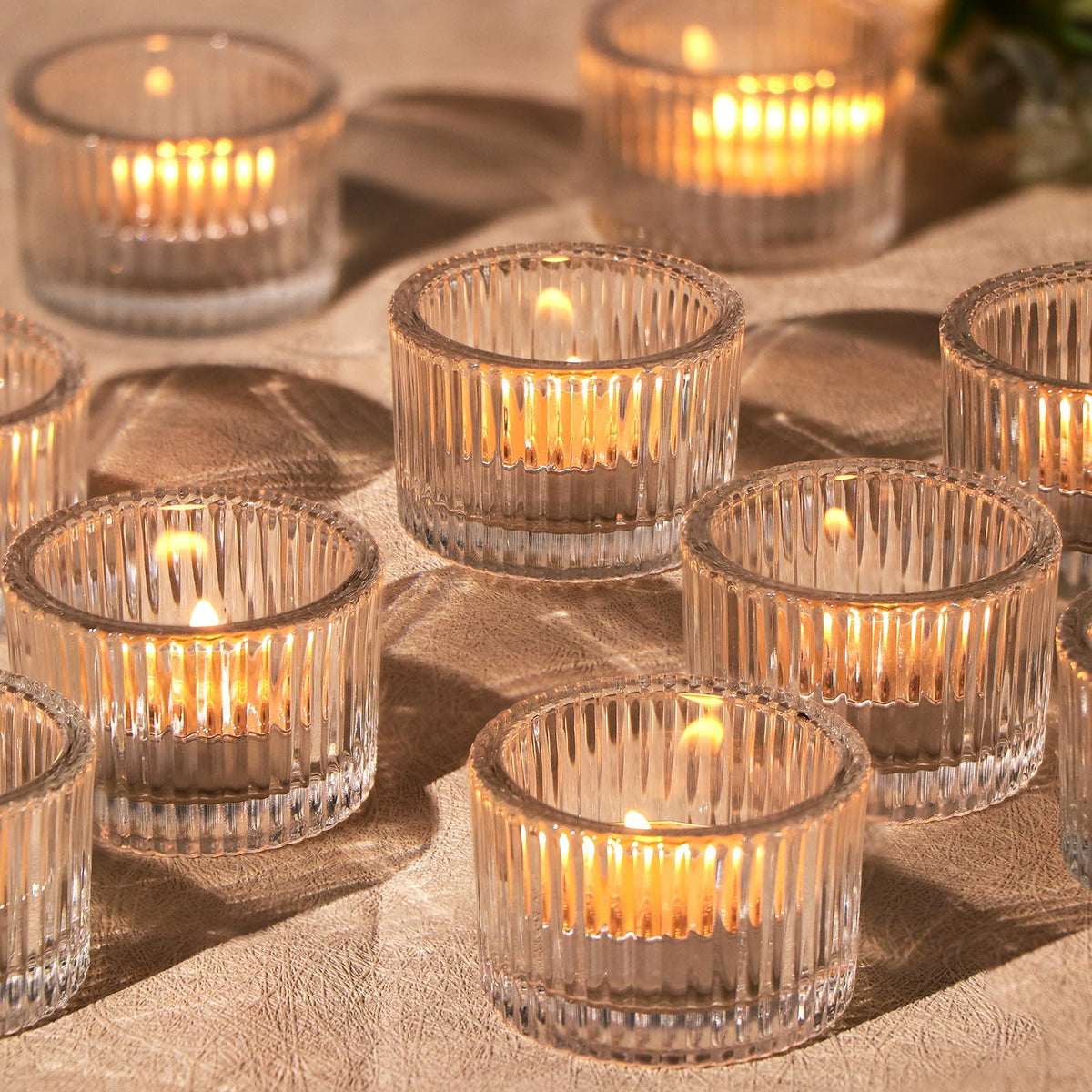 HAVITI 24-pack clear tealight holders for elegant wedding centerpieces and ambient home decor.
