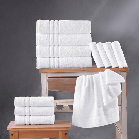 Hawmam Linen white towels folded in a stack highlights compact, lightweight design.