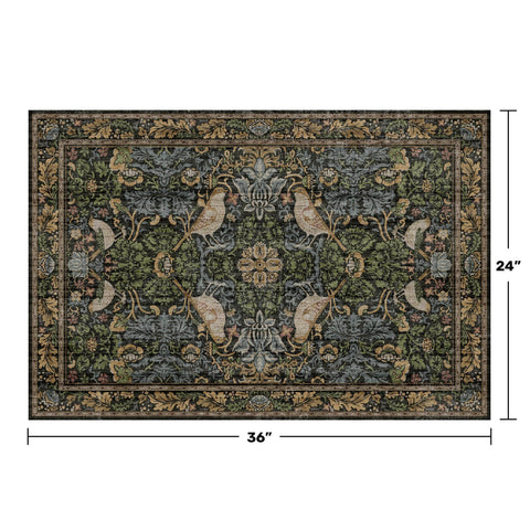 Hazo Haus rug close-up with bird and botanical motif in dark tones.