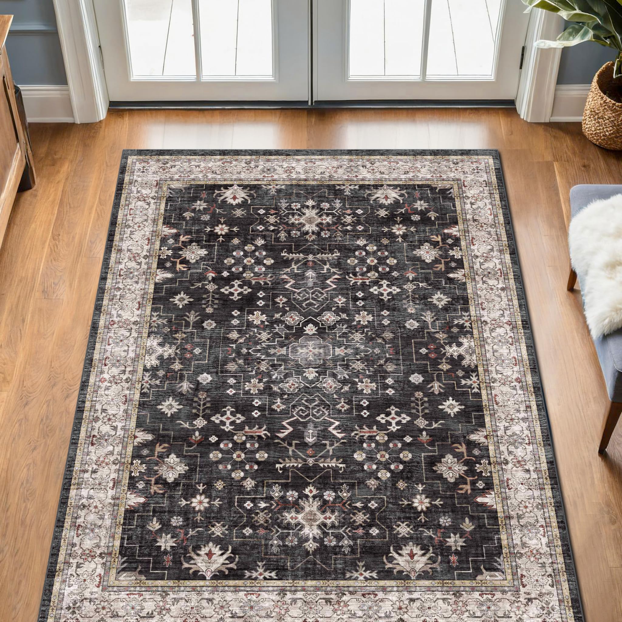 Hazo Haus Black Boho Entry Rug with non-slip backing on smooth floor.