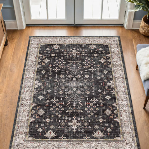 Hazo Haus Black Boho Entry Rug with non-slip backing on smooth floor.