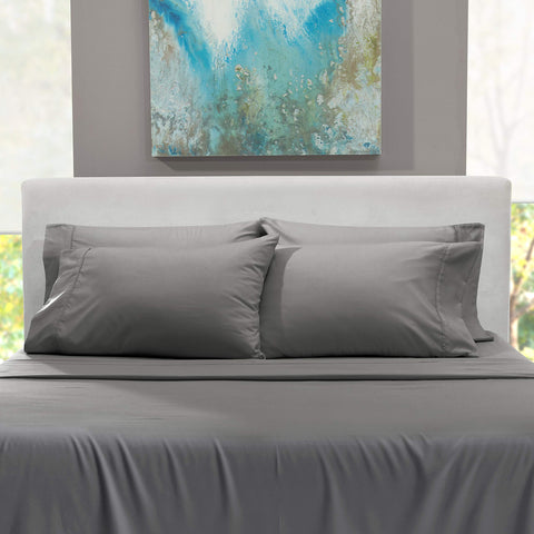 Cozy bedroom scene featuring Crisp Hearth and Harbor sheets in gray