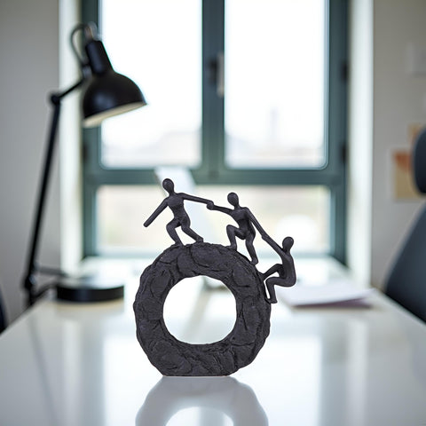 Hebdids textured matte black finish sculpture enhances room depth.