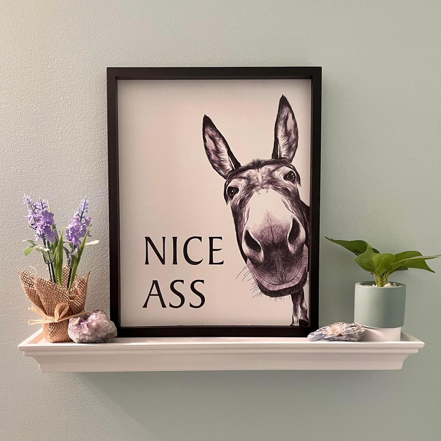 Heiple funny donkey print brightens powder room with bold black-and-white style.