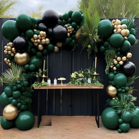 HIBAOpati black green gold balloon arch kit set up for dramatic graduation backdrop.