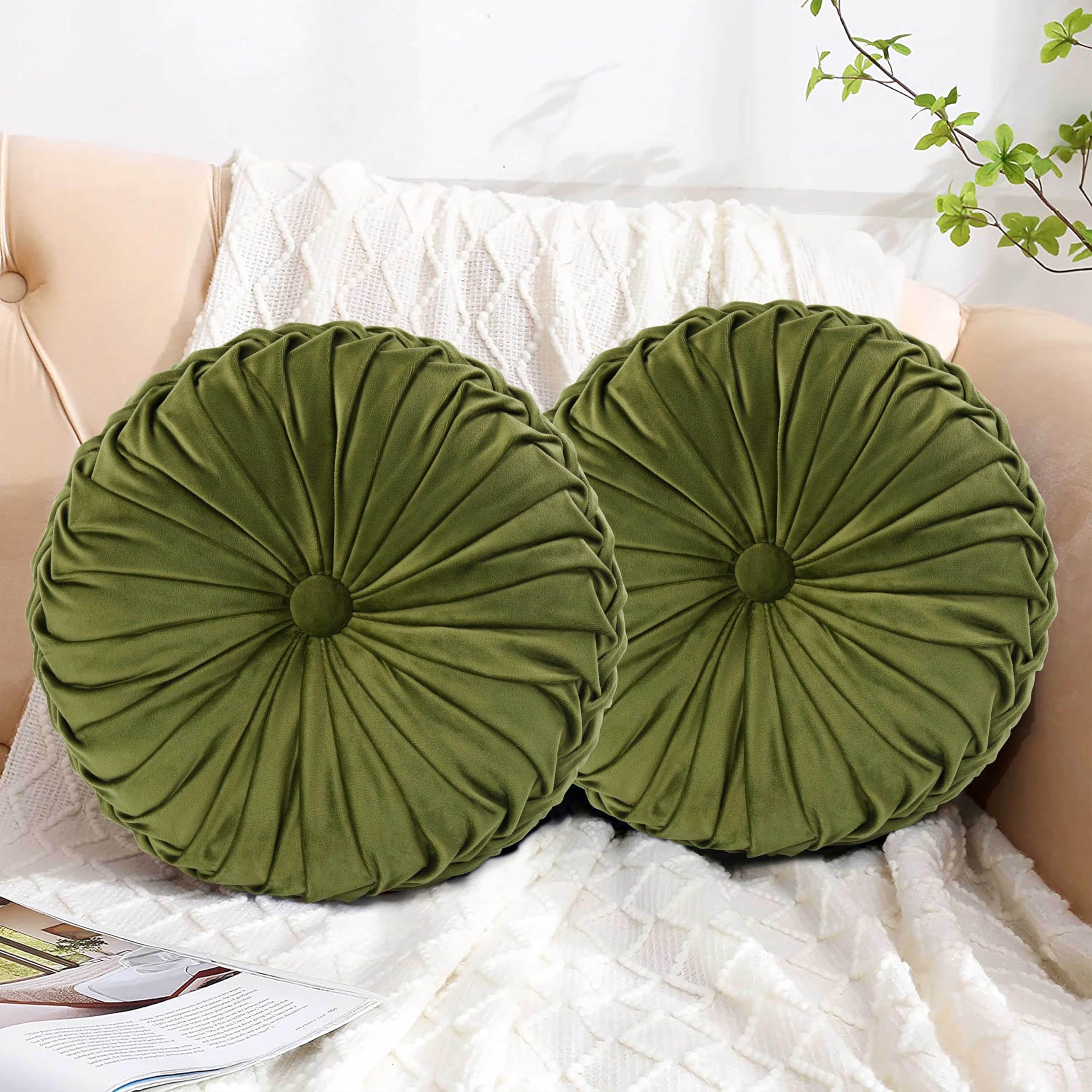 HIG hand-finished pleats on olive pillow emphasize premium craftsmanship.