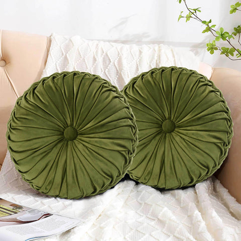HIG hand-finished pleats on olive pillow emphasize premium craftsmanship.