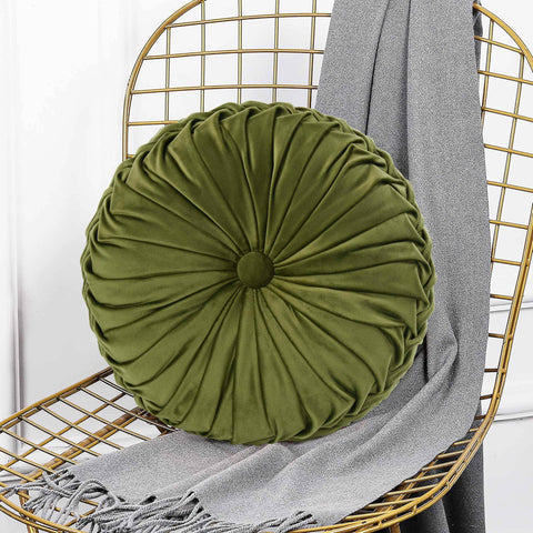 HIG olive pillow shown on bed for cozy seating and relaxation.