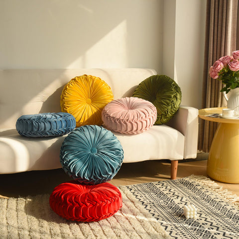 HIG pink ruched velvet round pillow on bed for cozy ambience