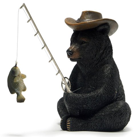 Hodao black bear fishing figurine on desk adds whimsical coastal decor.