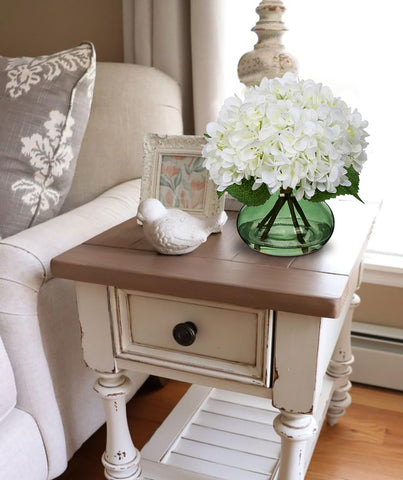Glass vase with faux water adds lifelike sparkle to shelves or tables.