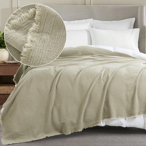 HOMBYS reversible linen blanket, soft side up, ideal for lounging on sofa or bed.