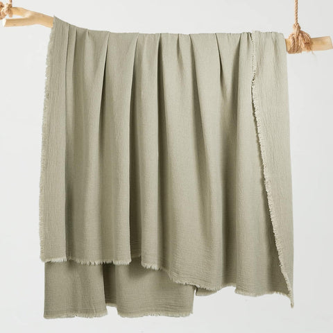 HOMBYS reversible blanket displayed to show dual-color option in flax