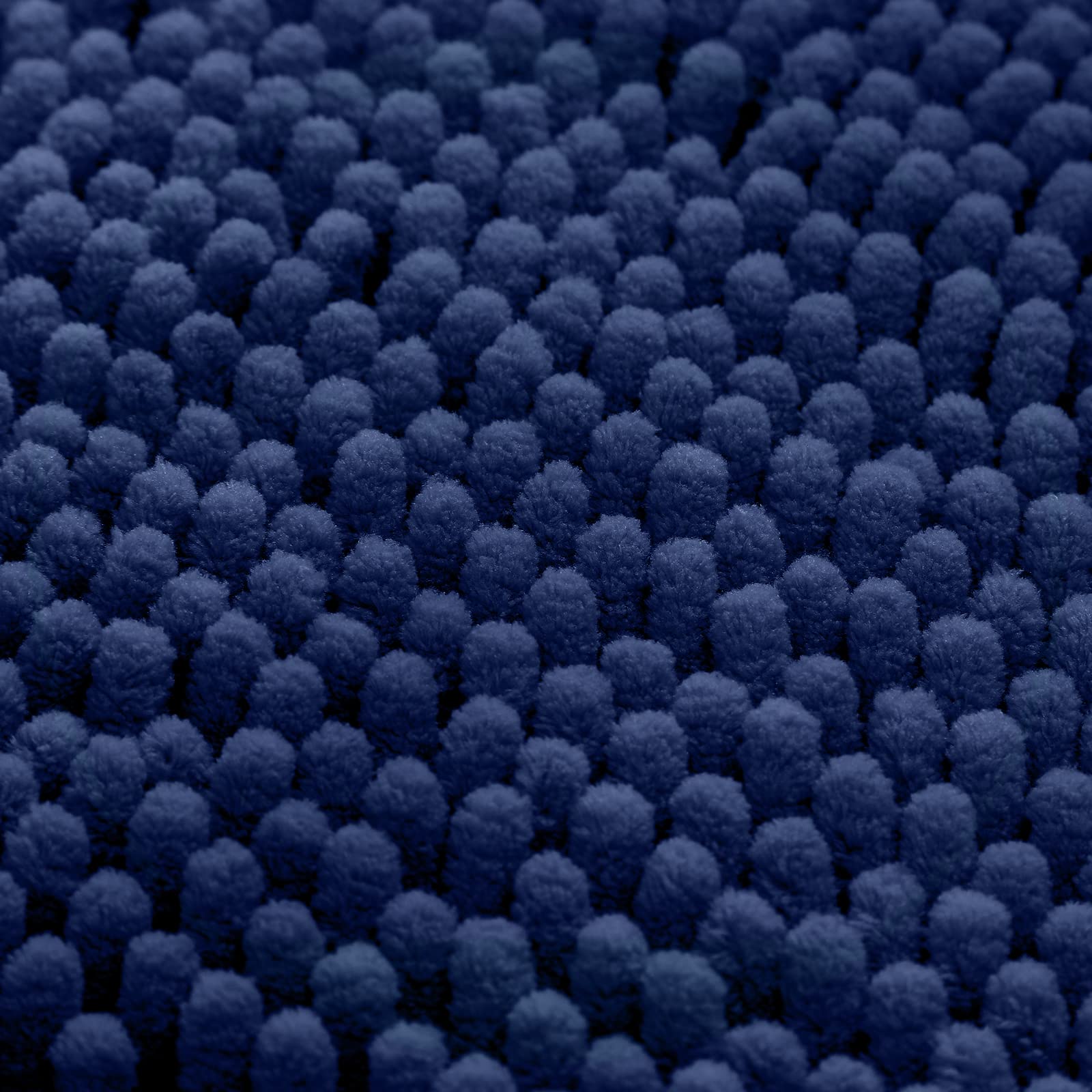 HOMEIDEAS Navy rug in a bathroom setting adds comfort