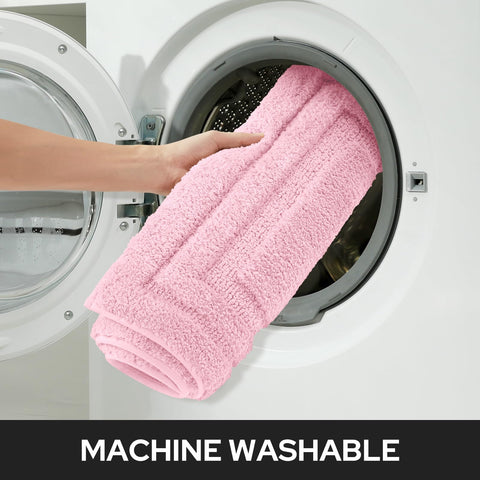 HOMEIDEAS pink bath rug placed in cozy bathroom decor.