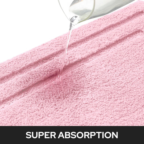 HOMEIDEAS pink bath rug back reveals non-slip backing for safety.
