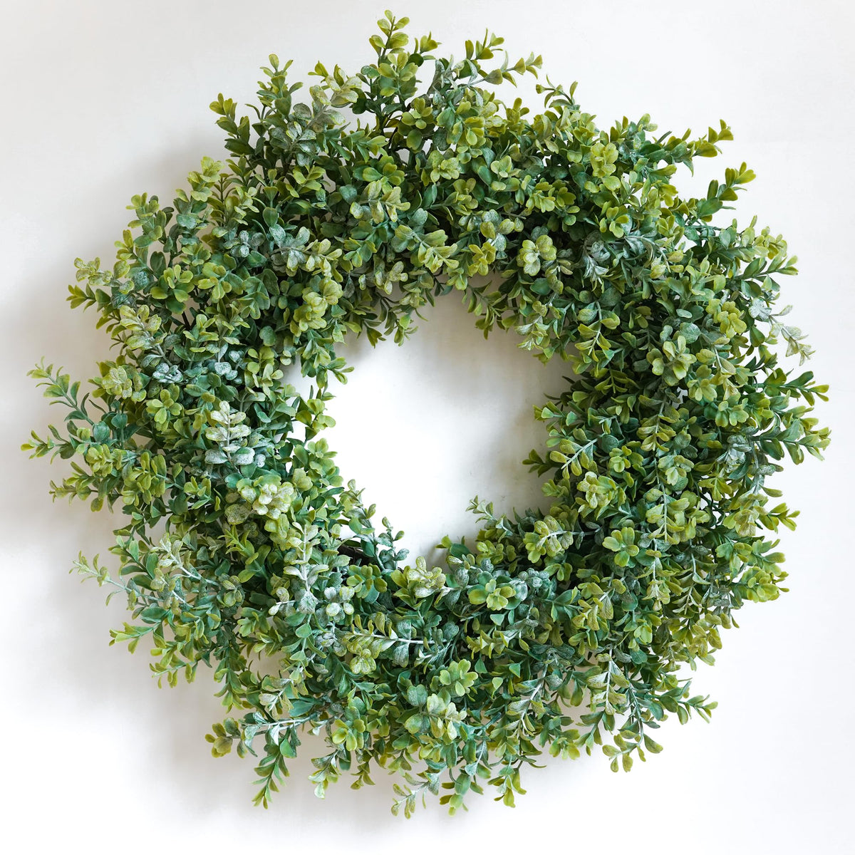 HomeKaren 24-inch front door wreath with eucalyptus and camellia adds year-round charm.