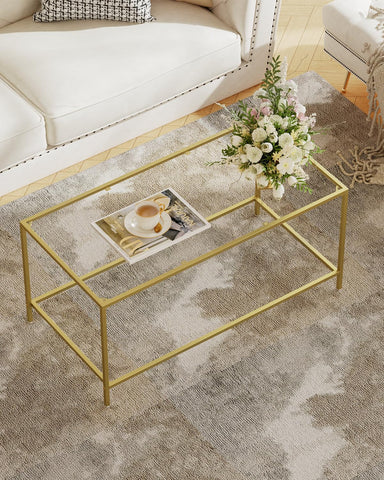Homleke glass coffee table with gold frame top in living rooms.