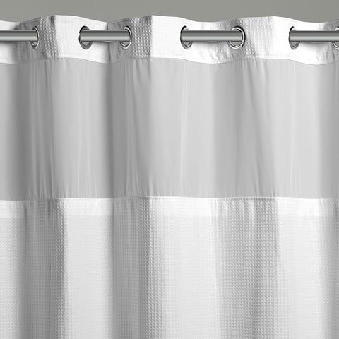 Hookless waffle fabric shower curtain lets light through while keeping water inside.