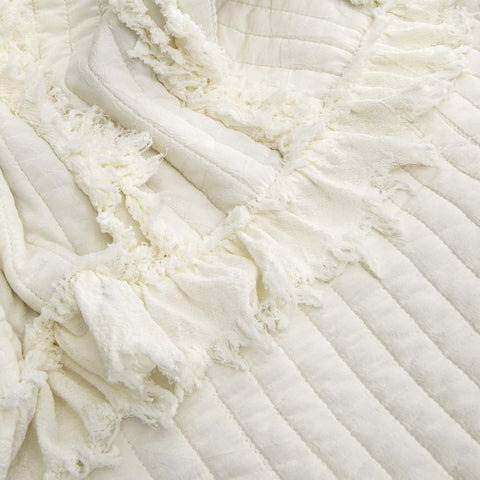 HORIMOTE HOME Quilted throw with ruffle edge adds vintage charm to any room.